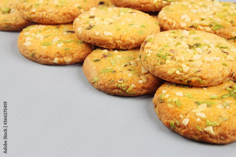 Home made sweet biscuits with mixed nuts on gray background Home made sweet biscuits with mixed nuts on gray background
