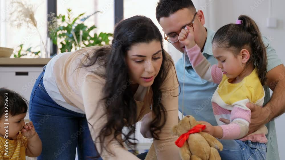 family, parenthood and people concept - happy mother, father, little daughter and baby son playing with toys at home family, parenthood and people concept - happy mother, father, little daughter and baby son playing with toys at home