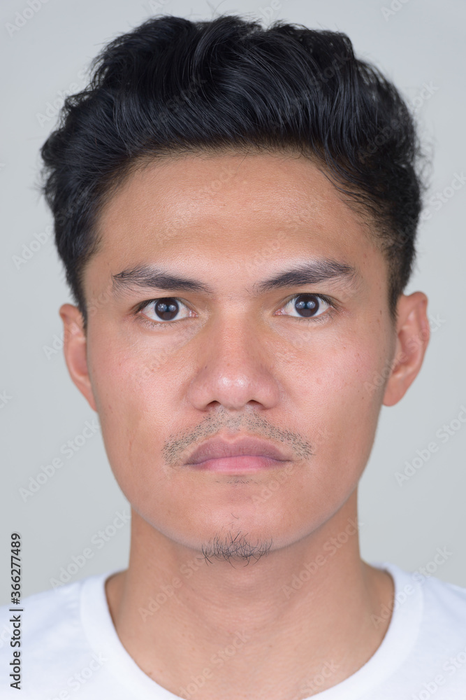 Face of handsome Asian man looking at camera Face of handsome Asian man looking at camera