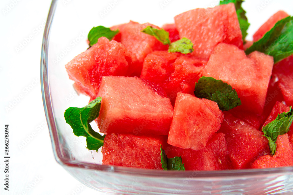Watermelon salad with mint close-up on white background Watermelon salad with mint close-up on white background
