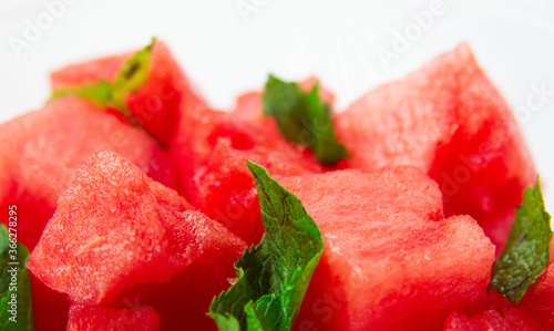Watermelon cubes with mint close-up on white background
