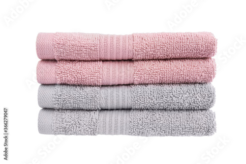 Pink and gray bath towels in stack isolated over white background with clipping path.