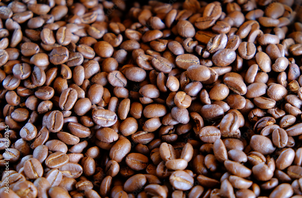group of roasted coffee beans, light and shadow on roasted coffee beans background group of roasted coffee beans, light and shadow on roasted coffee beans background