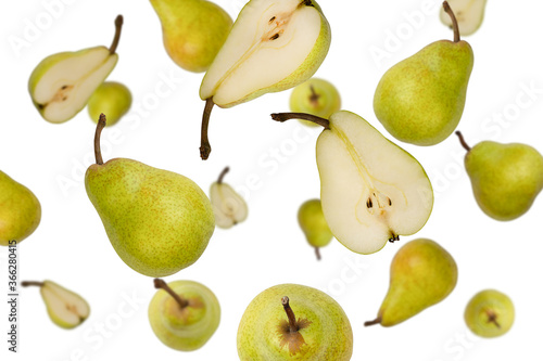 Falling whole and half green pears isolated on a white background with clipping path. Flying food, fruits. Top view