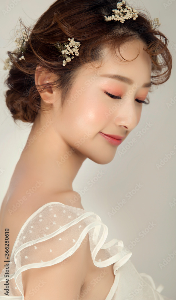 Beautiful young Asian woman with practical flower styling hairstyle