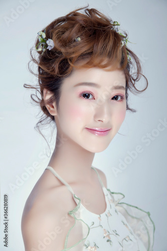 Beautiful young Asian woman with practical flower styling hairstyle