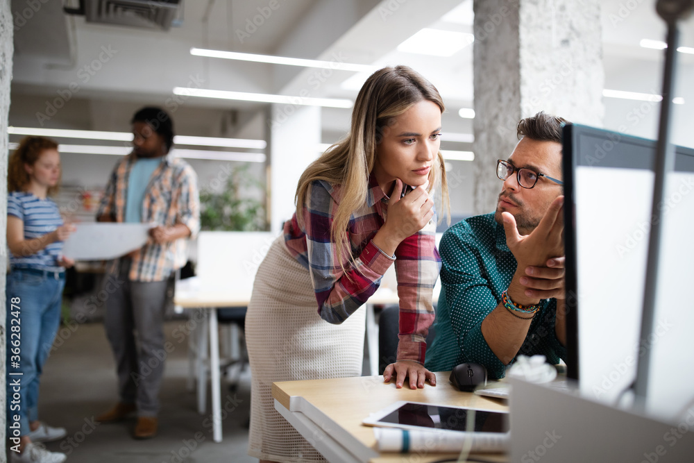 Programmers cooperating at IT company developing apps Programmers cooperating at IT company developing apps