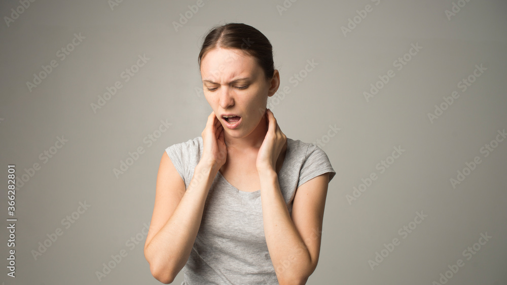 Obraz premium Tired woman feeling pain, massaging tense muscles