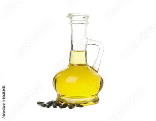 Glass jar of oil and seeds isolated on white background