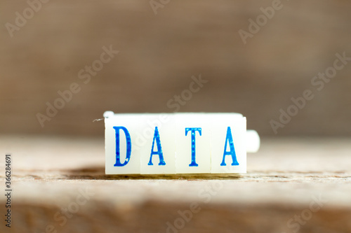 Letter block with blue color word data on wood background photo