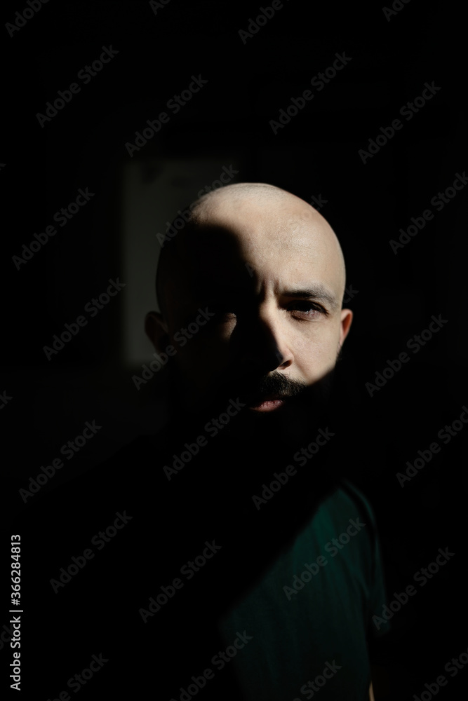 Abstract portrait of a man with a beard in the sun. Minimalism of the forms of light and shadow. Abstract portrait of a man with a beard in the sun. Minimalism of the forms of light and shadow.