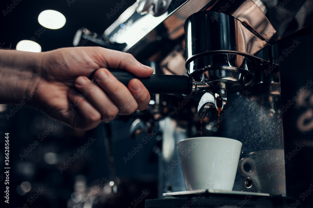 Barista hands during work - professional coffee brewing - the art of bartender Barista hands during work - professional coffee brewing - the art of bartender