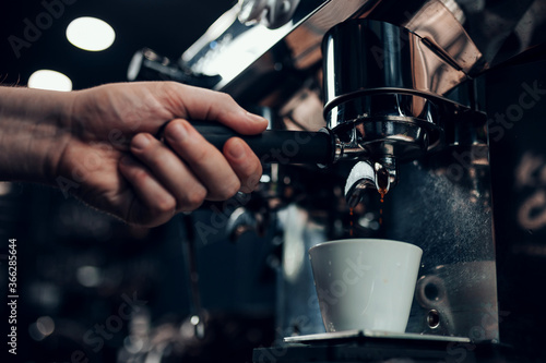 Barista hands during work - professional coffee brewing - the art of bartender