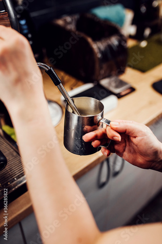 Barista hands during work - professional coffee brewing - the art of bartender