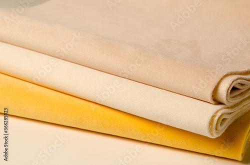 Bright yellow and white velour textile samples. Fabric texture background photo