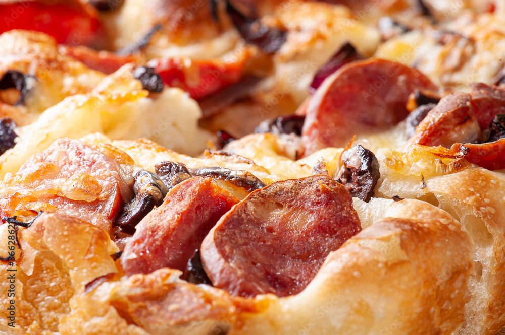 Traditional Italian Focaccia with pepperoni sausage, black olives