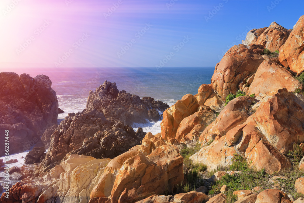 rocky ocean coastline with sunshine