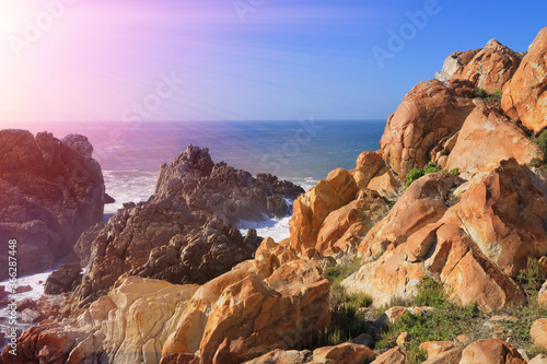 rocky ocean coastline with sunshine © mikefoto58