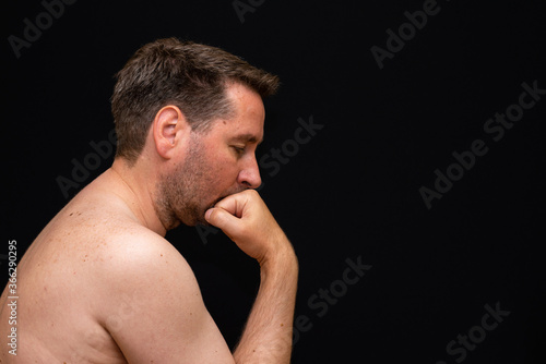 Side view sad thoughtful undressed handsome male demonstrating reverie.