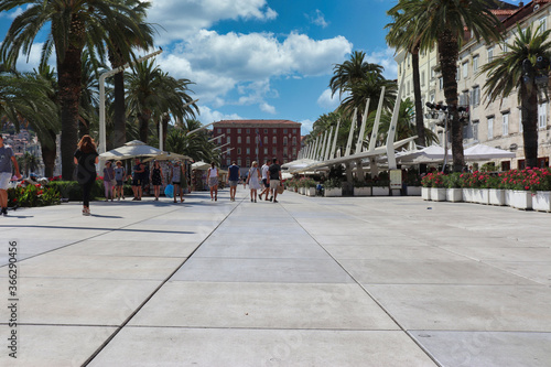 Split Croatia July 2019 Riva promenade near the sea in the old town of Split, tourist walking by on a hot summer day