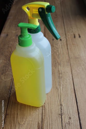 Disinfectants and detergents in plastic bottles on the table.