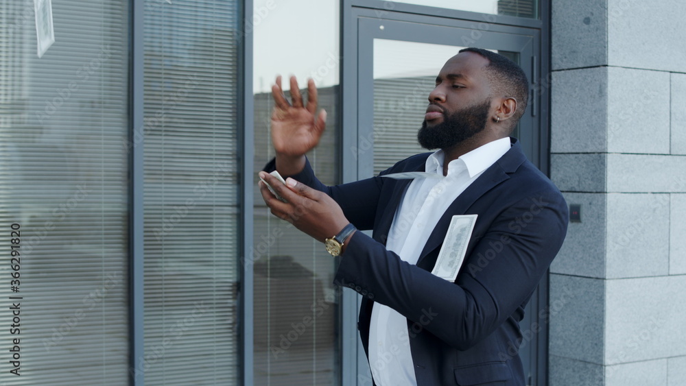 Businessman throwing money at street. Executive celebrating victory with cash