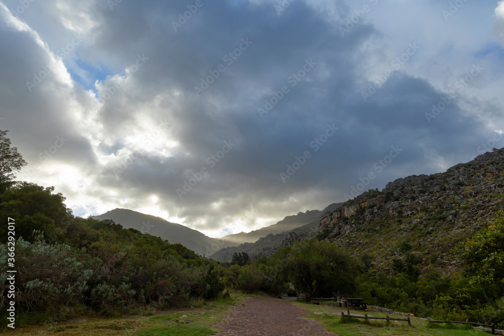 Rays of sunlight shine below the clouds late in the afternoon Rays of sunlight shine below the clouds late in the afternoon