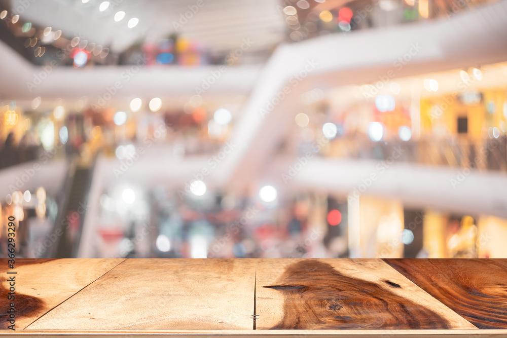 Wooden tabletop on blur people walking in shopping center mall abstract background. Wooden tabletop on blur people walking in shopping center mall abstract background.