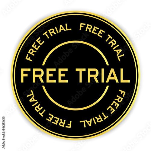 Black and gold color round sticker with word free trial on white background