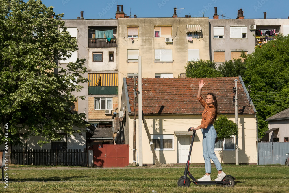 Fototapeta premium A young woman drive on an electric scooter