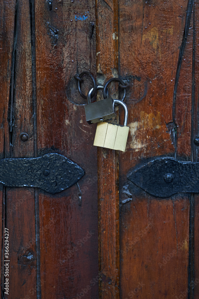 Locked wooden door. Closed for coronavirus pandemic quarantine Locked wooden door. Closed for coronavirus pandemic quarantine