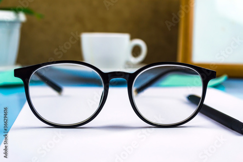 Black-rimmed glasses in the foreground