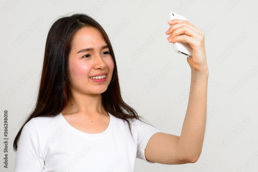 Portrait of happy young beautiful Asian woman Portrait of happy young beautiful Asian woman