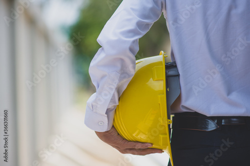 Wallpaper Mural Man engineer holding helmet hard hat work construction building Torontodigital.ca