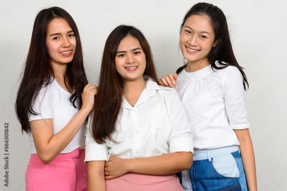 Three young beautiful Asian women as friends together Three young beautiful Asian women as friends together
