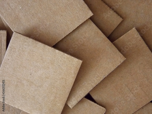 Pile of square pieces of cardboard close up