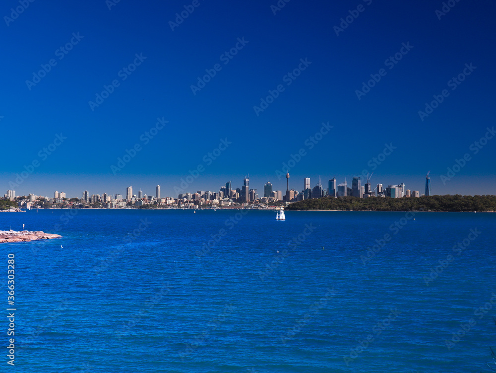 Panoramic view of Sydney Harbour in NSW Australia on a cold winters day blue skies with CBD in the background
