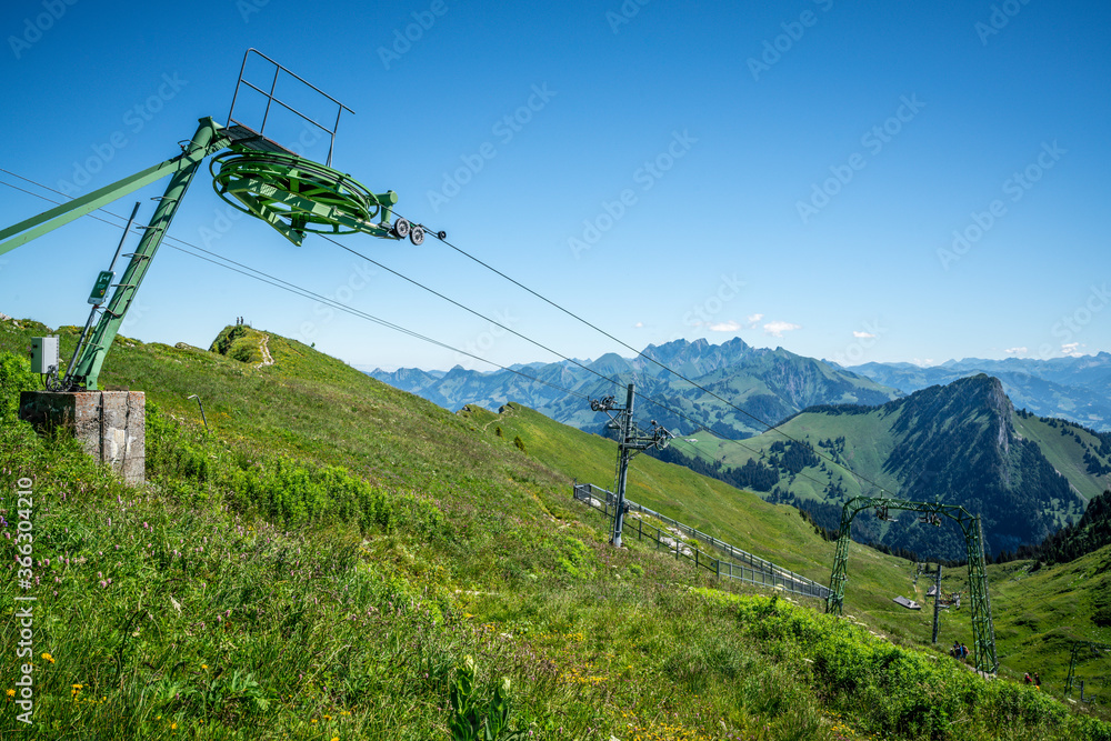 Ski lift during summer time and view of Swiss Alps in Switzerland