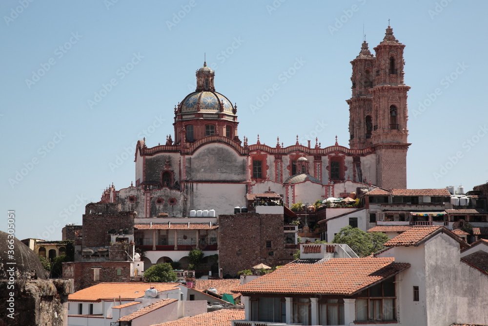 View of Santa Prisca Church and white houses with tile roofs in Taxco, Guerrero, Mexico