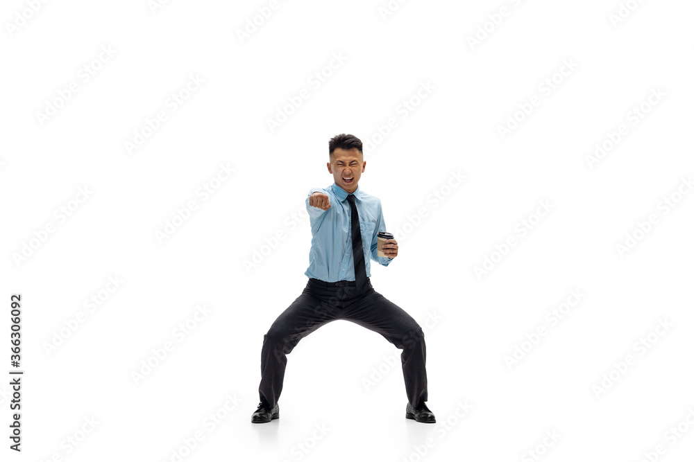 Target. Man in office clothes practicing taekwondo on white background like professional player, sportsman. Unusual look for businessman in motion, action with ball. Sport, healthy lifestyle