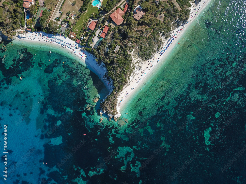 Drone view of Elba island northern coastline. Portoferraio and its white cliffs beaches. Capo Bianco. Italy
