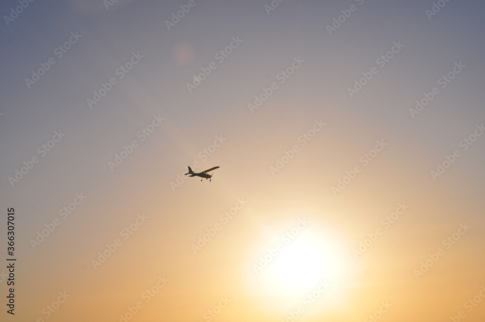 Airplane flying over Costa de la Luz into the sun, Cádiz, Spain