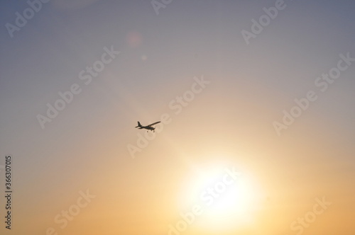 Airplane flying over Costa de la Luz into the sun, Cádiz, Spain