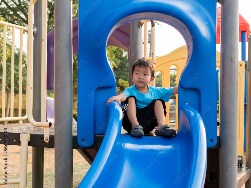 Asian child boy playing in playground. Young kid having happy moment in summer. Family activity and preschool concept. Asian child boy playing in playground. Young kid having happy moment in summer. Family activity and preschool concept.