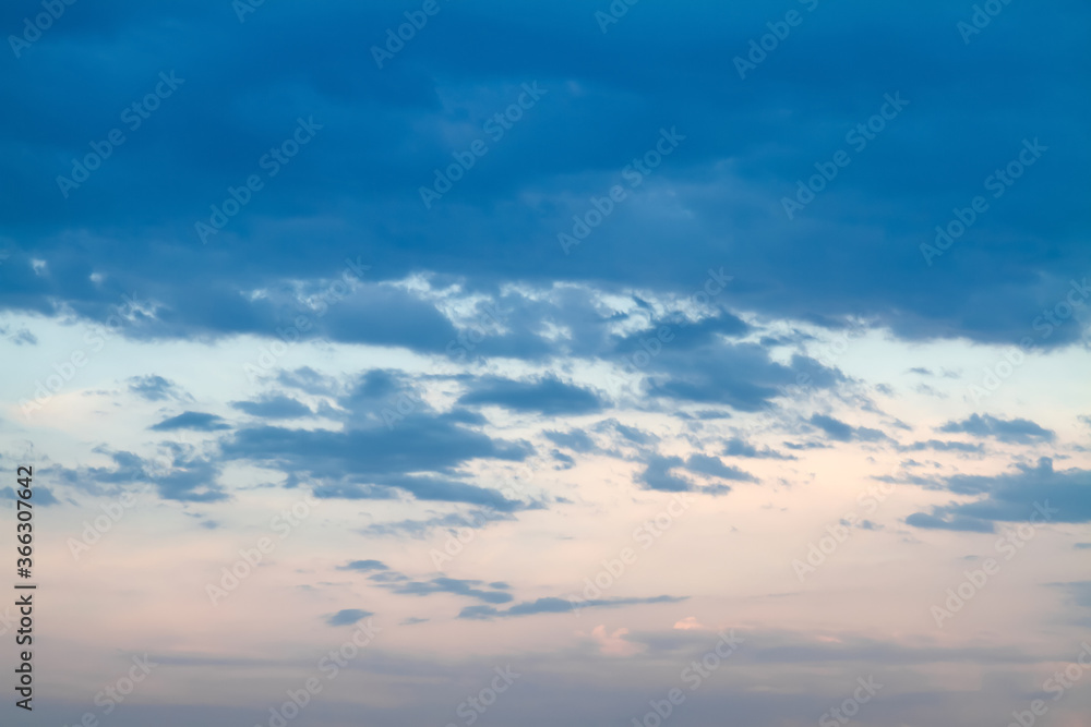 Blue sky background with white clouds on the sunset