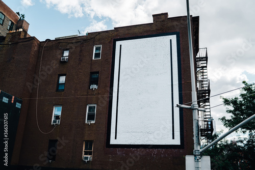 Photography Old vintage house facade from brownstone and with commercial blank billboard for advertising information in city, tall building with apartments and flats for rent in downtown and publicity area