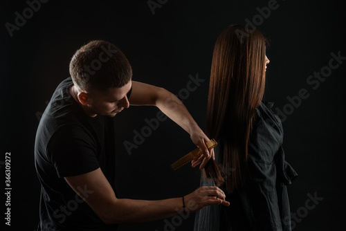 Student Hairdresser Cutting Hair. Hairdresser styling womans hair