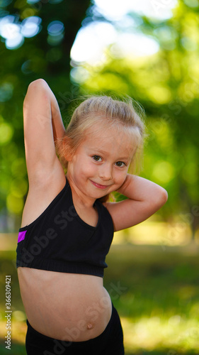 Portrait of young gymnast girl in sport black top