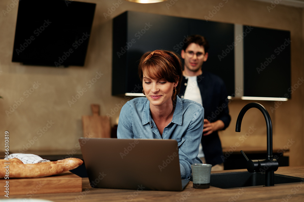 Couple working together in their kitchen Couple working together in their kitchen