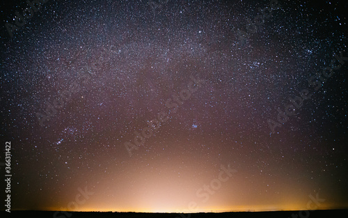Real Night Sky Stars Background With Natural Colourful Sky Gradient. Sunset, Sunrise Light And Starry Sky. Yellow And Blue Colors Over Horizon